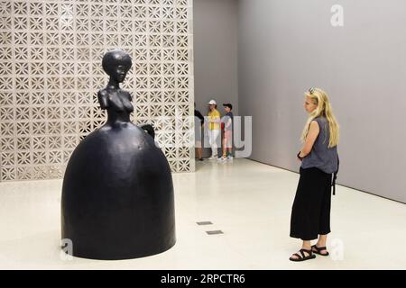 (190713) -- NEW YORK, July 13, 2019 -- A visitor views a statue at the exhibition the Hugo Boss Prize 2018: Simone Leigh, Loophole of Retreat at the Guggenheim Museum in New York, the United States, July 12, 2019. The Solomon R. Guggenheim Museum in New York City, often referred to as The Guggenheim, has been added to UNESCO s World Heritage List. The museum is among eight buildings in the United States that were inscribed on the list under the title of The 20th-Century Architecture of Frank Lloyd Wright. The announcement was made during the 43rd Session of the World Heritage Committee held in Stock Photo