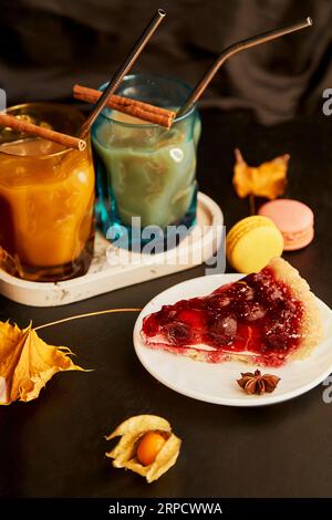 Cozy breakfast. Glasses of pumpkin latte and cherry pie. Seasonal autumn coffee time. Cozy hygge home aesthetic. Stock Photo