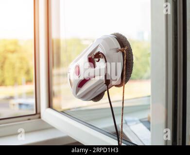 Clean windows safely with a window cleaning robot. Stock Photo