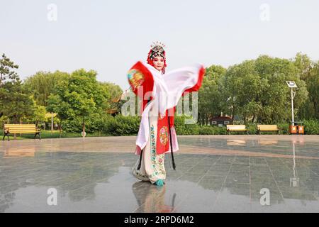 Luannan County, China - June 26, 2019: Peking Opera performers rehearse in the park, Luannan County, Hebei Province, China Stock Photo
