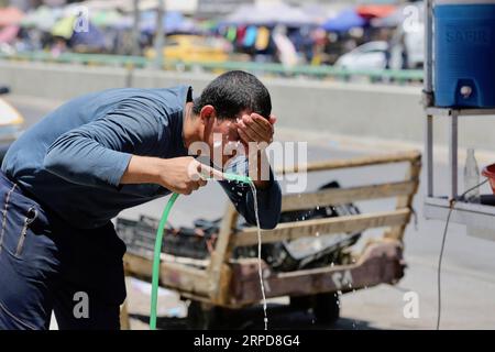 (190726) -- , July 26, 2019 -- A man washes his face to cool off amid high temperature in , Iraq, July 26, 2019. People in the Iraqi capital on Friday struggled to cope with the stifling heat as a new heatwave swept across the country. Khalil Dawood) IRAQ--HEATWAVE Baghdad PUBLICATIONxNOTxINxCHN Stock Photo