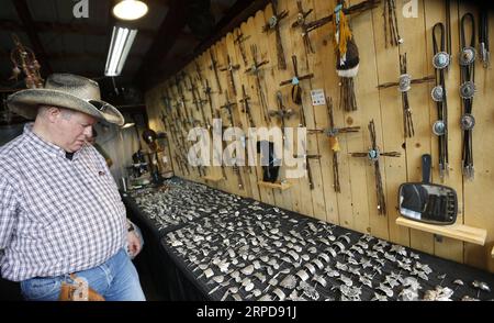 (190726) -- CHEYENNE (U.S.), July 26, 2019 -- A man purchases accessories at the Cheyenne Frontier Days in Cheyenne, the United States, July 24, 2019. Cheyenne Frontier Days is held here from July 19 to 28, featuring rodeo events, concerts, parades and art shows. ) U.S.-CHEYENNE-FRONTIER DAYS LixYing PUBLICATIONxNOTxINxCHN Stock Photo