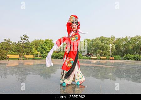 Luannan County, China - June 26, 2019: Peking Opera performers rehearse in the park, Luannan County, Hebei Province, China Stock Photo