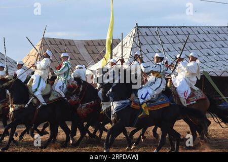 (190728) -- RABAT, July 28, 2019 (Xinhua) -- Performers in traditional costumes ride horses during a Fantasia horse show in Rabat, Morocco, on July 28, 2019. A Fantasia horse show was held to celebrate the 20th anniversary of the enthronement of Moroccan King Mohammed VI on Sunday. Fantasia is a traditional exhibition of horsemanship performed during cultural festivals and wedding celebrations. (Photo by Chadi/Xinhua) MOROCCO-RABAT-HORSE SHOW-FANTASIA PUBLICATIONxNOTxINxCHN Stock Photo