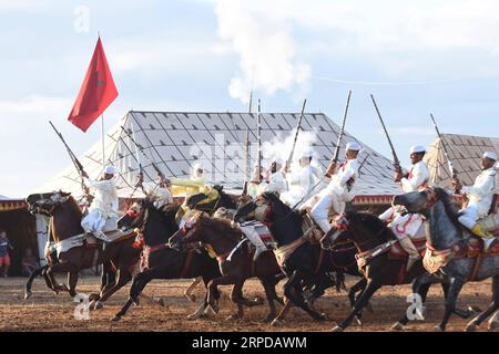 (190728) -- RABAT, July 28, 2019 (Xinhua) -- Performers in traditional costumes ride horses during a Fantasia horse show in Rabat, Morocco, on July 28, 2019. A Fantasia horse show was held to celebrate the 20th anniversary of the enthronement of Moroccan King Mohammed VI on Sunday. Fantasia is a traditional exhibition of horsemanship performed during cultural festivals and wedding celebrations. (Photo by Chadi/Xinhua) MOROCCO-RABAT-HORSE SHOW-FANTASIA PUBLICATIONxNOTxINxCHN Stock Photo