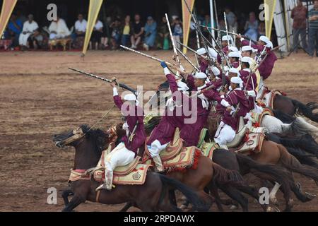 (190728) -- RABAT, July 28, 2019 (Xinhua) -- Performers in traditional costumes ride horses during a Fantasia horse show in Rabat, Morocco, on July 28, 2019. A Fantasia horse show was held to celebrate the 20th anniversary of the enthronement of Moroccan King Mohammed VI on Sunday. Fantasia is a traditional exhibition of horsemanship performed during cultural festivals and wedding celebrations. (Photo by Chadi/Xinhua) MOROCCO-RABAT-HORSE SHOW-FANTASIA PUBLICATIONxNOTxINxCHN Stock Photo