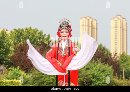 Luannan County, China - June 26, 2019: Peking Opera performers rehearse in the park, Luannan County, Hebei Province, China Stock Photo