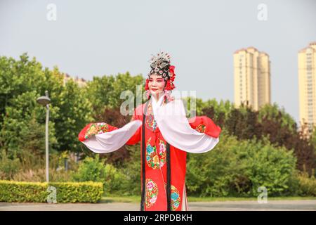 Luannan County, China - June 26, 2019: Peking Opera performers rehearse in the park, Luannan County, Hebei Province, China Stock Photo