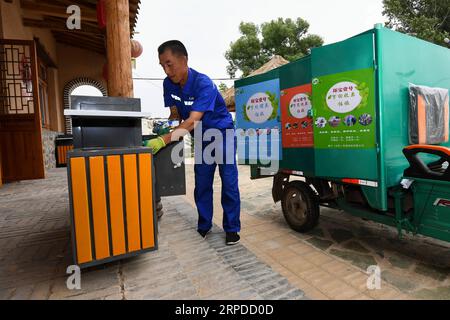 (190731) -- CHIFENG, July 31, 2019 -- Villager Zhang Yukui cleans garbage bins in Xiaomiaozi Village of Damiao Township in Chifeng City, north China s Inner Mongolia Autonomous Region, July 16, 2019. ) CHINA-INNER MONGOLIA-COUNTRYSIDE-GARBAGE SORTING LiuxLei PUBLICATIONxNOTxINxCHN Stock Photo