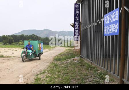 (190731) -- CHIFENG, July 31, 2019 -- Villager Zhang Yukui transports garbage bins in Xiaomiaozi Village of Damiao Township in Chifeng City, north China s Inner Mongolia Autonomous Region, July 16, 2019. ) CHINA-INNER MONGOLIA-COUNTRYSIDE-GARBAGE SORTING LiuxLei PUBLICATIONxNOTxINxCHN Stock Photo