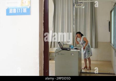 (190731) -- NANCHANG, July 31, 2019 -- Liu Xiaoqing is pictured during class hour at the Luxi County Special Education School in Luxi County of Pingxiang, east China s Jiangxi Province, July 3, 2019. When the Luxi County Special Education School was established in 1997, Liu Xiaoqing, then a normal university graduate, applied for a post there without hesitation. Working as a special education teacher has been challenging, as Liu s students need far more attention than their peers without physical or mental disabilities. But Liu stayed on her post for 22 years helping her students improve with Stock Photo