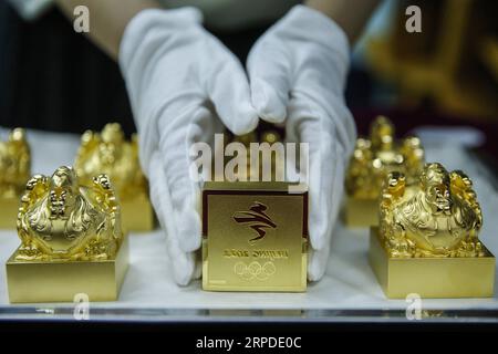(190801) -- BEIJING, Aug. 1, 2019 -- A staff member shows the emblem seals of the Beijing 2022 Winter Olympic Games, July 29, 2019. Authorized by the Beijing Organizing Committee of the Olympic and Paralympic Winter Games, emblem seals made of Hetian greenish white jade and gold were set to be issued with limited numbers later this week, announced the BOCOG on July 31, 2019. A total of 2,022 jade seals and 5,000 gold ones will be released to the market on Saturday, according to the organizers. ) XINHUA PHOTOS OF THE DAY ZhangxYuwei PUBLICATIONxNOTxINxCHN Stock Photo