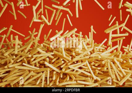 French fries falling down and forming the pile. Fast food. Chips. Red background Stock Photo