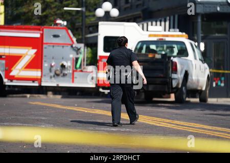 (190804) -- DAYTON (U.S.), Aug. 4, 2019 -- A policewoman walks near the scene of mass shooting in Dayton of Ohio, the United States, on Aug. 4, 2019. Local police on Sunday identified the suspect of a shooting spree in the city of Dayton, U.S. state of Ohio, as Connor Betts, a 24-year-old white male. In a press conference, Dayton Mayor Nan Whaley said it took less than a minute for the shooter to claim the lives of nine people, including Betts 22-year-old sister Megan Betts, before being killed by the police. ) U.S.-OHIO-DAYTON-MASS SHOOTING-AFTERMATH LiuxJie PUBLICATIONxNOTxINxCHN Stock Photo