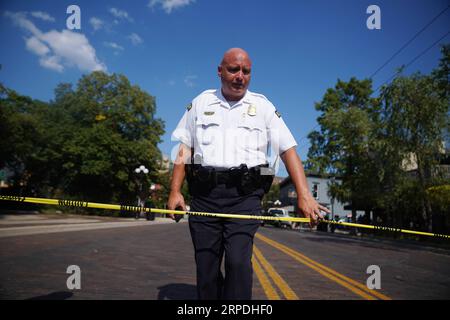 (190804) -- DAYTON (U.S.), Aug. 4, 2019 -- A policeman stands guard near the scene of mass shooting in Dayton of Ohio, the United States, on Aug. 4, 2019. Local police on Sunday identified the suspect of a shooting spree in the city of Dayton, U.S. state of Ohio, as Connor Betts, a 24-year-old white male. In a press conference, Dayton Mayor Nan Whaley said it took less than a minute for the shooter to claim the lives of nine people, including Betts 22-year-old sister Megan Betts, before being killed by the police. ) U.S.-OHIO-DAYTON-MASS SHOOTING-AFTERMATH LiuxJie PUBLICATIONxNOTxINxCHN Stock Photo