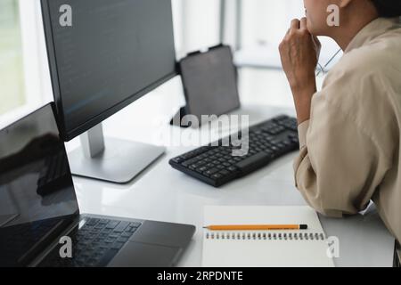 Developer programmer checking code on monitor while programming to developing web and application. Stock Photo