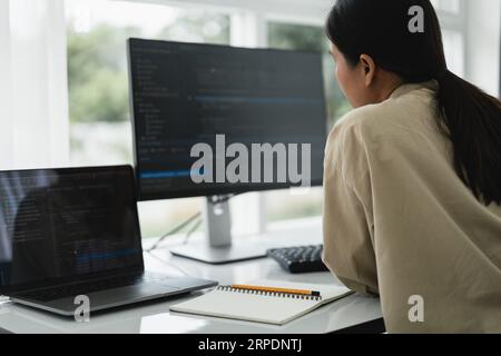 Developer programmer checking code on monitor while programming to developing web and application. Stock Photo