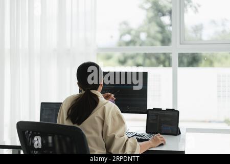 Developer programmer use mouse and checking code on laptop while programming to developing website. Stock Photo
