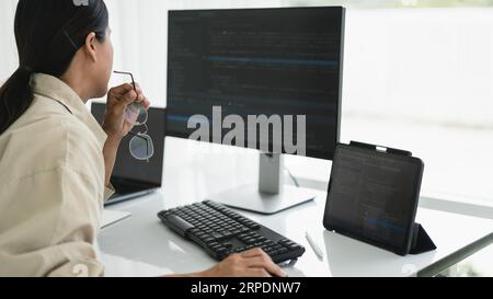 Developer programmer working to checking code on monitor while programming to developing website. Stock Photo