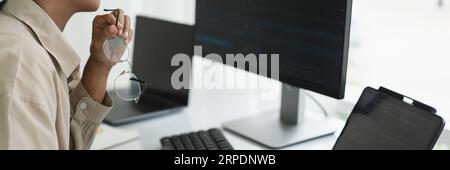 Developer programmer working to checking code on monitor while programming to developing website. Stock Photo