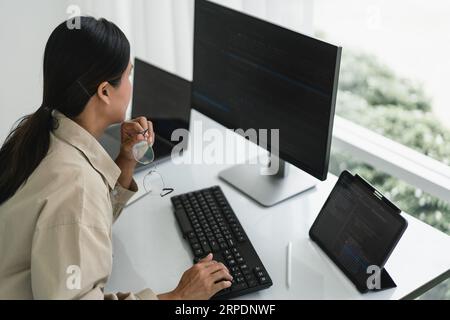 Developer programmer working to checking code on monitor while programming to developing website. Stock Photo
