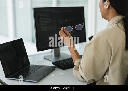 Developer programmer working to checking code on monitor while programming to developing website. Stock Photo