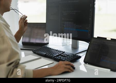 Developer programmer working to checking code on monitor while programming to developing website. Stock Photo