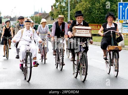 (190810) -- PRAGUE, Aug. 10, 2019 (Xinhua) -- Cyclists take part in a commemorative ride in Kutna Hora, the Czech Republic, Aug. 10, 2019. Dozens of cyclists in traditional clothing rode historical bikes and passed through the central Czech city of Kutna Hora on Saturday afternoon to celebrate the 150th anniversary of the first bike race on the Czech land. The first cycling race in Bohemia was said to be held in Kutna Hora on Aug. 8, 1869 on the road between Kutna Hora and Sedlec. (Photo by Dana Kesnerova/Xinhua) CZECH REPUBLIC-KUTNA HORA-BIKE RACE-COMMEMORATION PUBLICATIONxNOTxINxCHN Stock Photo