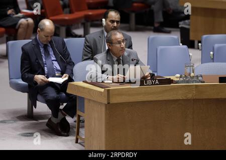 (190810) -- UNITED NATIONS, Aug. 10, 2019 -- Elmahdi S. Elmajerbi (front), Charge d affaires of Libya to the United Nations, addresses a Security Council emergency meeting on the situation in Libya at the UN headquarters in New York, Aug. 10, 2019. United Nations Security Council on Saturday strongly condemned the car bomb attack in Benghazi, Libya, in which three UN staff members were killed and several others injured. ) UN-SECURITY COUNCIL-EMERGENCY MEETING-LIBYA LixMuzi PUBLICATIONxNOTxINxCHN Stock Photo