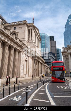 London, UK - 18 April 2022: The exterior of the Bank of England on Threadneedle street, with a red London bus passing by. Stock Photo