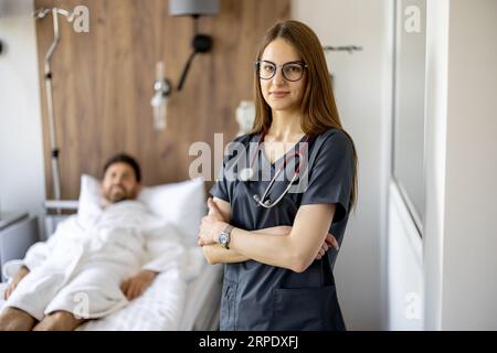 Portrait of a young female nurse in medical ward Stock Photo