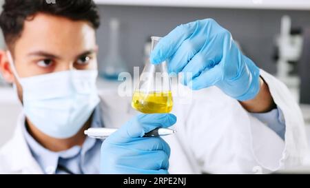 A thinking young scientist doing research to create a covid cure in a lab. Medical professional using science equipment in a laboratory. A serious Stock Photo