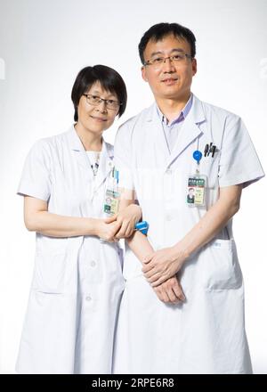 (190819) -- BEIJING, Aug. 19, 2019 -- Liu Hongsheng (R), associate chief physician of thoracic surgery department, and his wife Ni Jun, chief physician of neurology department, pose for a photo at their work place of the Peking Union Medical College Hospital in Beijing, capital of China, Aug. 16, 2019. China has about 3.6 million qualified physicians and 4.1 million registered nurses. They have formed a strong force to support the most significant medical service system in the world of safeguarding the health of 1.4 billion people in the country. China designated Aug. 19 as Medical Workers Day Stock Photo
