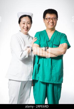 (190819) -- BEIJING, Aug. 19, 2019 -- Yi Jie (R), chief physician of anesthesiology department, and his wife Lu Yue, supervisor nurse of ophthalmology department, pose for a photo at their work place of the Peking Union Medical College Hospital in Beijing, capital of China, Aug. 16, 2019. China has about 3.6 million qualified physicians and 4.1 million registered nurses. They have formed a strong force to support the most significant medical service system in the world of safeguarding the health of 1.4 billion people in the country. China designated Aug. 19 as Medical Workers Day last year to Stock Photo