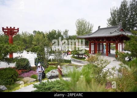 (190823) -- BEIJING, Aug. 23, 2019 -- Visitors tour the Shaanxi Garden at the Beijing International Horticultural Exhibition in Beijing, capital of China, Aug. 22, 2019. As a land-locked province, Shaanxi stretches the drainage areas of the Yangtze River and the Yellow River, the two longest rivers in China. It boasts main parts of the Qinling Mountains, one of the biodiversity hotspots worldwide, dividing northern temperate zones from subtropical zones. Meanwhile, Shaanxi is habitat of rare protected animals. Over the past years, Shaanxi Province has been promoting ecological development. For Stock Photo