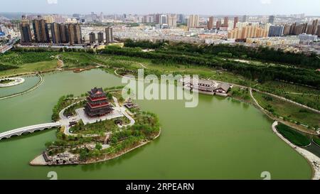 (190823) -- BEIJING, Aug. 23, 2019 -- Aerial photo taken on June 4, 2019 shows a park in Yuyang District of Yulin, northwest China s Shaanxi Province. As a land-locked province, Shaanxi stretches the drainage areas of the Yangtze River and the Yellow River, the two longest rivers in China. It boasts main parts of the Qinling Mountains, one of the biodiversity hotspots worldwide, dividing northern temperate zones from subtropical zones. Meanwhile, Shaanxi is habitat of rare protected animals. Over the past years, Shaanxi Province has been promoting ecological development. For example, Yan an, c Stock Photo