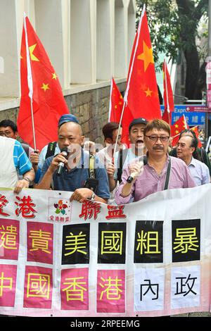 (190827) -- HONG KONG, Aug. 27, 2019 -- Protesters march to the U.S. Consulate General in China s Hong Kong Special Administrative Region (HKSAR) during a demonstration against the U.S. interference in China s domestic affairs in south China s Hong Kong, Aug. 26, 2019. More than 100 people held a demonstration on Monday in front of the U.S. Consulate General in Hong Kong to protest against the U.S. interference in China s domestic affairs. The demonstrators, holding up Chinese national flags and banners high and chanting slogans, started in the afternoon from Chater Garden in the Central distr Stock Photo