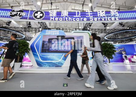 Beijing, China. 4th Sep, 2023. Visitors walk past the exhibition area of healthcare services of the 2023 China International Fair for Trade in Services (CIFTIS) at Shougang Park in Beijing, capital of China, Sept. 4, 2023. Credit: Zhang Yuwei/Xinhua/Alamy Live News Stock Photo