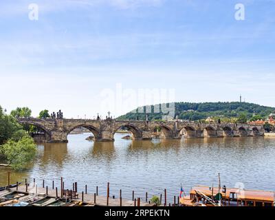 The medieval Charles Bridge over the Vltava River in Prague has 30 mostly Baroque statues along its length. Stock Photo