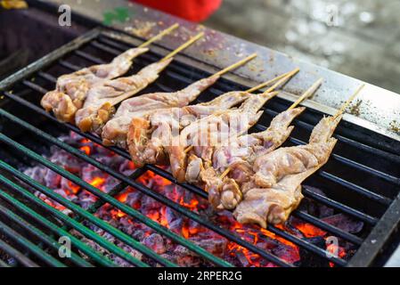 Raw chicken wings for bbq on grill in Jalan Alor street food in Kuala Lumpur Stock Photo