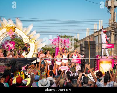 Barranquilla, Atlantico, Colombia - February 18 2023: Men and Women Dressed in White and Pink on a Float in the Carnival Parade Waving to the Crowd Stock Photo
