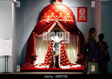 (190904) -- BEIJING, Sept. 4, 2019 -- Visitors walk past a set of costumes during an exhibition held at Prince Kung s Mansion in Beijing, capital of China, Sept. 4, 2019. An exhibition featuring replicas of textile artworks used by Danish noble families from the 17th to 21st centuries kicked off in Prince Kung s Mansion on Wednesday. Apart from displaying exhibits collected by the Museum of National History at Frederiksborg Castle in Denmark, the textile exhibition also showcased embroidered artworks designed by Queen Margrethe II of Denmark. ) CHINA-BEIJING-EXHIBITION-DENMARK-TEXTILES (CN) Cu Stock Photo