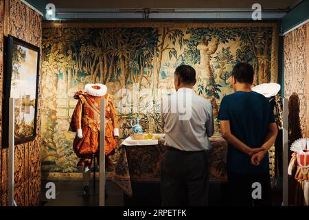 (190904) -- BEIJING, Sept. 4, 2019 -- Visitors view exhibits during an exhibition held at Prince Kung s Mansion in Beijing, capital of China, Sept. 4, 2019. An exhibition featuring replicas of textile artworks used by Danish noble families from the 17th to 21st centuries kicked off in Prince Kung s Mansion on Wednesday. Apart from displaying exhibits collected by the Museum of National History at Frederiksborg Castle in Denmark, the textile exhibition also showcased embroidered artworks designed by Queen Margrethe II of Denmark. ) CHINA-BEIJING-EXHIBITION-DENMARK-TEXTILES (CN) CuixBowen PUBLIC Stock Photo