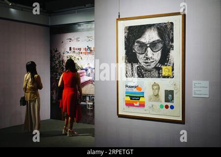 (190904) -- BEIJING, Sept. 4, 2019 -- Visitors view a painting during an exhibition held at Prince Kung s Mansion in Beijing, capital of China, Sept. 4, 2019. An exhibition featuring paintings by Danish artist Kasper Eistrup kicked off in Prince Kung s Mansion on Wednesday. The painting exhibition showed mostly portraits of contemporary musicians by Eistrup, who is also a former singer and guitarist. ) CHINA-BEIJING-EXHIBITION-DENMARK-PAINTINGS (CN) CuixBowen PUBLICATIONxNOTxINxCHN Stock Photo