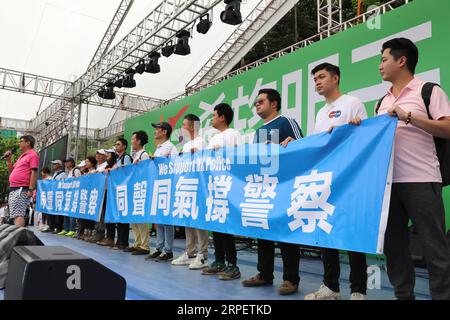 (190905) -- BEIJING, Sept. 5, 2019 -- People take part in a rally to denounce violence and support police force at Victoria Park in Hong Kong, south China, Aug. 3, 2019. Xinhua Headlines: Hong Kong police: doxxed, ambushed, yet still resolute WuxXiaochu PUBLICATIONxNOTxINxCHN Stock Photo