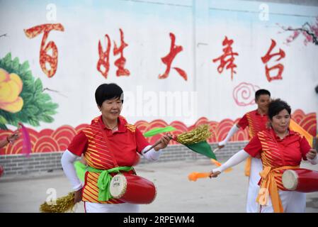 (190905) -- BEIJING, Sept. 5, 2019 -- People perform waist drum dance in a square in Liulou Township of Jining, east China s Shandong Province, Aug. 8, 2019. Rural revitalization strategy was first put forward during the 19th National Congress of the Communist Party of China in 2017 and repeatedly stressed by the Chinese leadership since then. The strategy s overall goal is to build rural areas with thriving businesses, pleasant living environments, social etiquette and civility, effective governance, and prosperity. ) CHINA-RURAL DEVELOPMENT (CN) WangxKai PUBLICATIONxNOTxINxCHN Stock Photo