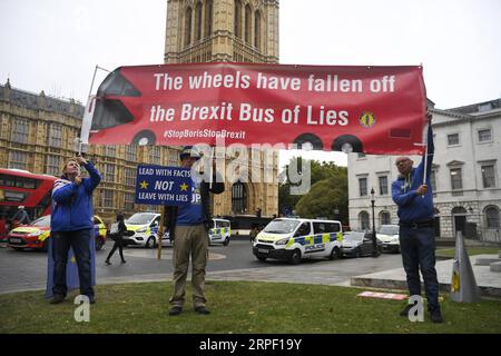 (190909) -- LONDON, Sept. 9, 2019 -- Demonstrators gather outside the Houses of Parliament holding placards in London, Britain, on Sept. 9, 2019. The British parliament will be prorogued at the close of business on Monday night until Oct. 14, Downing Street confirmed. The move came after Prime Minister Boris Johnson requested the Queen to allow such a suspension, from a date this week until Oct. 14. (Photo by Alberto Pezzali/Xinhua) BRITAIN-LONDON-BREXIT-PARLIAMENT-PROROGATION HanxYan PUBLICATIONxNOTxINxCHN Stock Photo