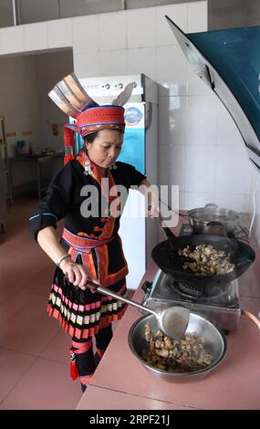 (190910) -- NANNING, Sept. 10, 2019 -- Teacher Tao Fengying makes lunch for students at a teaching point in Zhongliang Town, Jinxiu Yao Autonomous County, south China s Guangxi Zhuang Autonomous Region, June 4, 2019. Since 2012, reporter has visited 250 teachers in remote mountain areas in Guangxi and recorded their lives. Teachers there always fill multiple roles, such as concierge and cook. There are about 16.74 million teachers in China, a 79 percent surge from the figure in 1985 when China designated Sept. 10 as Teachers Day, the Ministry of Education said. A total of 510,000 new graduates Stock Photo