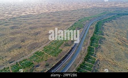 (190910) -- BEIJING, Sept. 10, 2019 -- Aerial photo taken on June 26, 2018 shows the Baotou-Lanzhou railway in Zhongwei City, northwest China s Ningxia Hui Autonomous Region. Located in the northwestern China, Ningxia is rich in natural beauties ranging from waterside landscape to scenery in cold regions. As an important protection barrier of ecological system in northwestern China, Ningxia plays a significant role in safeguarding the whole country s ecological environment. Surrounded by deserts on three sides, Ningxia is faced with arduous tasks on desertification control. With 70 years of ef Stock Photo