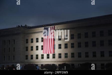 (190912) -- BEIJING, Sept. 12, 2019 -- The U.S. flag is unfurled at sunrise during a ceremony marking the 18th anniversary of the 9/11 terrorist attacks at the Pentagon, the United States, on Sept. 11, 2019. ) XINHUA PHOTOS OF THE DAY LiuxJie PUBLICATIONxNOTxINxCHN Stock Photo